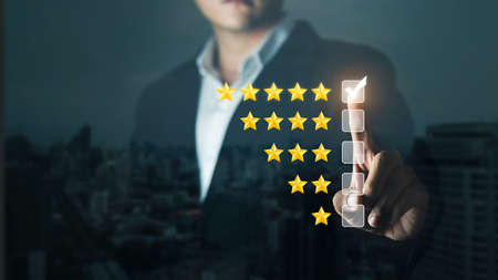 Businessman User give rating to service experience on online application, Customer review satisfaction feedback survey concept,  Customer can evaluate quality of service leading to reputation ranking of business.の写真素材