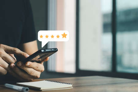 User give rating to service experience on online application, Customer review satisfaction feedback survey concept, Customer can evaluate quality of service leading to reputation ranking of business.の写真素材