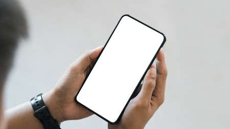 mockup copy space phone, man's hand holding smartphone with blank white copy screen for your...
