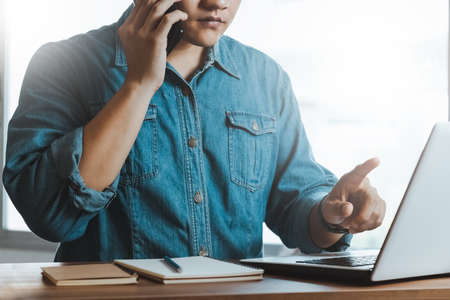 Work using mobile phone typing computer mobile chat laptop contact us at workplaces, planning ideas investors internet searching, ideas connecting people.の写真素材