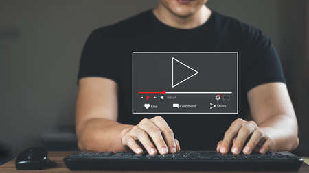 Human hands use laptops in the morning, to watch online streaming, watch video on the Internet, watch live concerts, shows or online lessons. There is sunshine in the morning.の写真素材