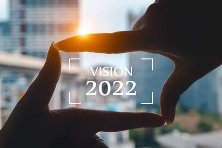 New year 2022 starts the concept of businessmen framing and vision 2022 by hand, the concept of planning and challenges or career paths, business strategies opportunities and change.の写真素材