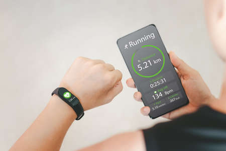 The idea of health care innovation, fitness technology, by wearing a smart watch and smartphone.