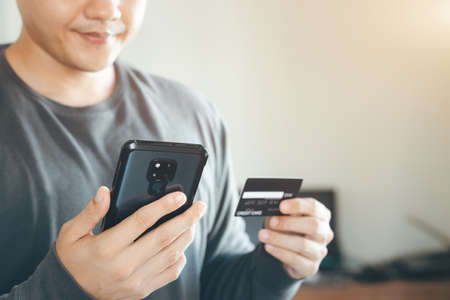 businessmen use their credit cards through mobile internet banking apps to shop online and digital payment ideas.の写真素材