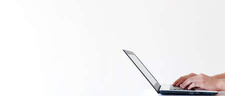 Banner of laptop and young man hands with copy space in white color background.の写真素材