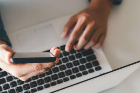 Work using mobile phone typing computer mobile chat laptop contact us at workplaces, planning ideas investors internet searching, ideas connecting people.の写真素材