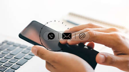 Hand of Businessman hand touching on mobile phone screen. Contact Us, customer support concept, Help...