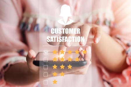 User give rating to service experience on online application, Customer review satisfaction feedback survey concept, Customer can evaluate quality of service leading to reputation ranking of business.の写真素材