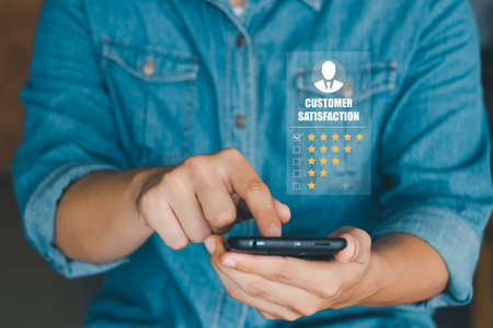 User give rating to service experience on online application, Customer review satisfaction feedback survey concept, Customer can evaluate quality of service leading to reputation ranking of business.の写真素材