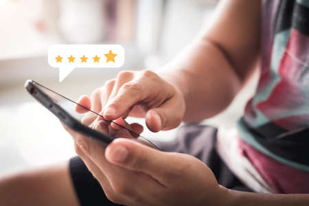 User give rating to service experience on online application, Customer review satisfaction feedback survey concept, Customer can evaluate quality of service leading to reputation ranking of business.の写真素材