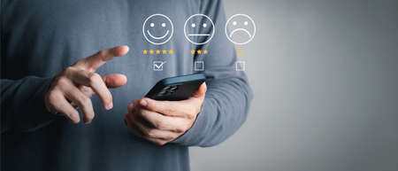 User give rating to service experience on online application, Customer review satisfaction feedback survey concept, Customer can evaluate quality of service leading to reputation ranking of business.の写真素材