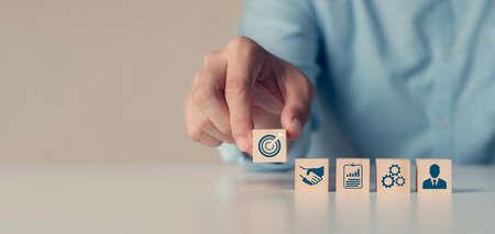 hand woods block cube with icon company strategy development, Concept success, and business goalsの写真素材