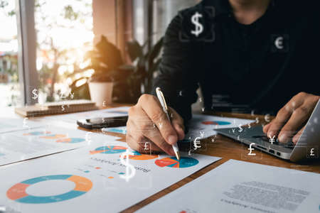 Businessman analysis business report graph and finance chart at Coffee Shop, conceptual of finance...