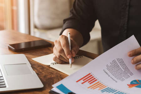 male executive analyzing and planning business sales performance from financial data, analyzing finance sales data and economic growth graph chart.の写真素材