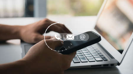 Hand of Businessman holding mobile smartphone. Contact Us, customer support concept. copy space.