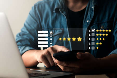User give rating to service experience on online application, Customer review satisfaction feedback survey concept, Customer can evaluate quality of service leading to reputation ranking of business.の写真素材