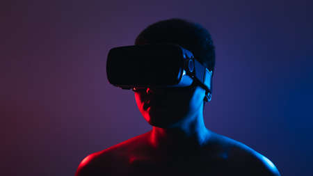 Young man wearing VR goggles. Metaverse technology virtual reality concept. Virtual Reality Device,...