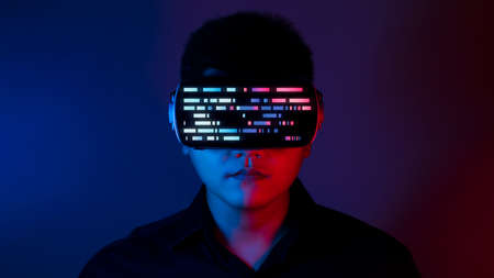 Young man wearing VR goggles. Metaverse technology virtual reality concept. Virtual Reality Device,...