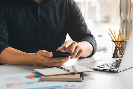 Work using mobile phone typing computer mobile chat laptop contact us at workplaces, planning ideas investors internet searching, ideas connecting people.の写真素材