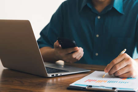 male executive analyzing and planning business sales performance from financial data, analyzing...