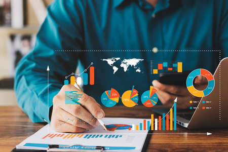 Businessman touching virtual screen Graph analysis of business growth and investment, strategic planning to increase sales profits, long-term business plan.の写真素材