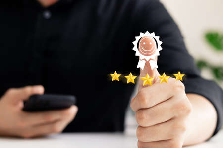 Customer Satisfaction Survey Concept, Customer Hand Thumbs Up good mood gym face icon Show five-star satisfaction rating, the best service rating for satisfaction.の写真素材