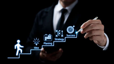 Businessmen point to successful business growth plans, ladder of success, action planning and long-term business goals.の写真素材