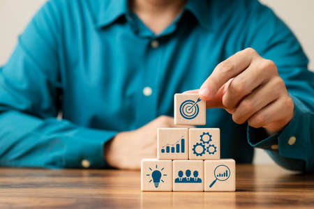 hand woods block cube with icon company strategy development, Concept success and business goals.の写真素材