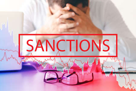 Global economic sanctions concept, business man holding his temple Stress from foreign joint economic sanctions, trade war.の写真素材