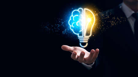 Businessman holding a virtual bulb and half-brain, innovation through ideas and ideas that inspire...