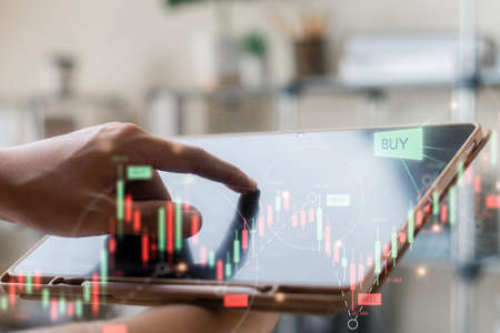 Businessmen work with stock market investments using laptop to analyze trading data. smartphone with...