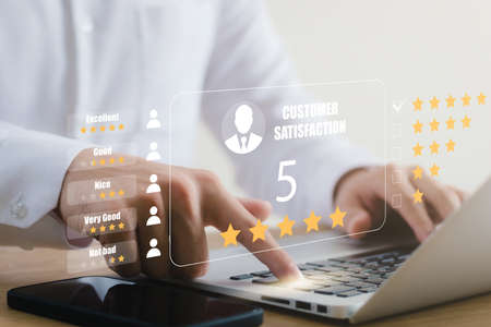 User give rating to service experience on online application, Customer review satisfaction feedback survey concept, Customer can evaluate quality of service leading to reputation ranking of business.の写真素材