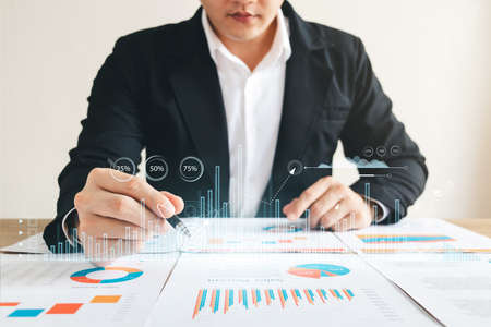 Businessman touching virtual screen Graph analysis of business growth and investment, strategic...