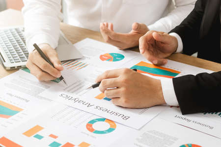 business teamwork Calculating Profit and Cost with Calculator, Growth Chart Analysis and Investing...