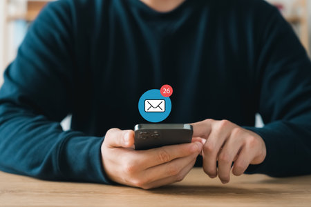 Email or newsletter concept, businessman using smartphone with email or newsletter notifications.の写真素材