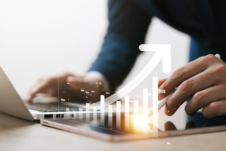 Businessman use laptop and tablet analyzing company growth, future business growth arrow graph, development to achieve goals, business outlook, financial data for long term investment.の写真素材