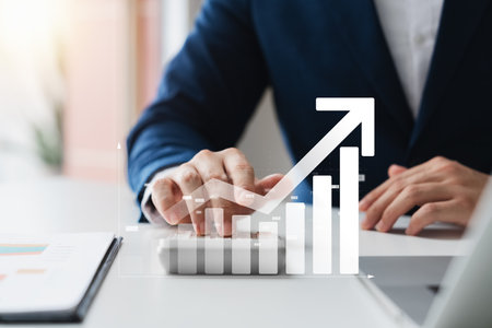 Businessman use laptop and tablet analyzing company growth, future business growth arrow graph, development to achieve goals, business outlook, financial data for long term investment.の写真素材