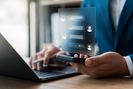 Businessmen use smartphones and laptops with AI applications to help them optimize their work to...