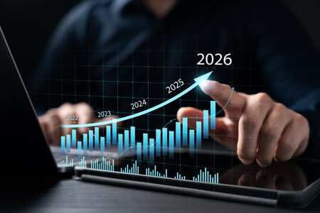 New Business Plan Setting Goals for the New Year 2026, businessman using laptop and tablet to strategize and develop the organization to grow to success in 2026, finding business opportunities.の写真素材