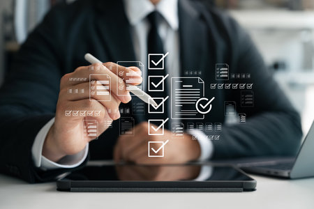 Business checklist management and performance tracking, businessman using laptop with digital document icons check mark and online document approval, digital form checklist, filling out online survey.の写真素材