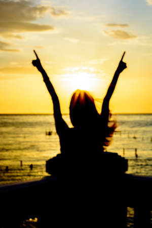 woman under the sunset at seaの写真素材