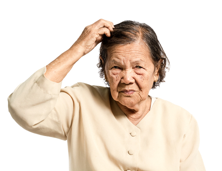 Portrait of a senior woman confused in vintage costume. Isolated on white backgroundの写真素材
