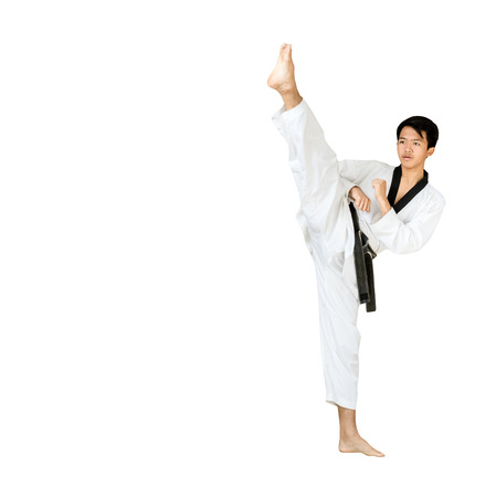 Portrait of a handsome asian man kick with taekwondo black belt . Isolated on white background with copy spaceの写真素材