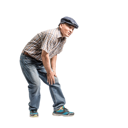 Portrait of a mature man with knee pain. Isolated full body on white background with copy spaceの写真素材