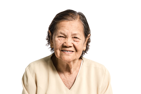 Portrait of a senior woman smiling with vintage costume. Isolated on white backgroundの写真素材