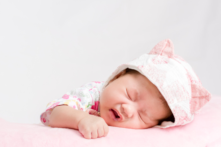 Portrait of adorable baby girl with hatの写真素材