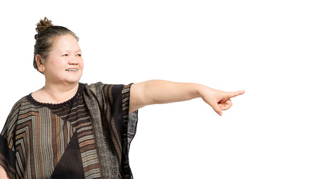 portrait of a mature woman pointed the finger to the right side. Isolated on white background with copt space and clipping pathの写真素材