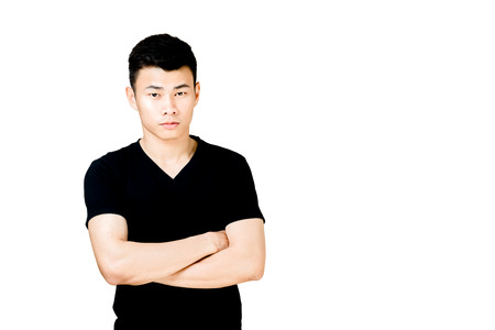 Portrait of a man with arms fold in black t-shirt. Isolated on white background with copy space and clipping pathの写真素材