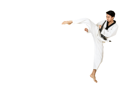 Portrait of an asian professional taekwondo black belt degree (Dan) jumping for kick. Isolated full length on white background with copy space and clipping pathの写真素材