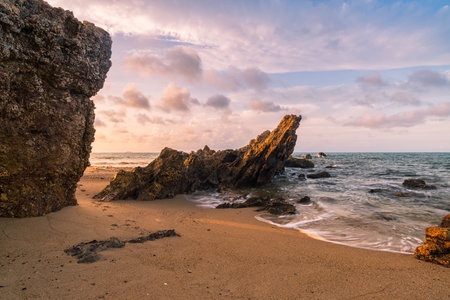 Group of rocks at sea in early morning with calm waves